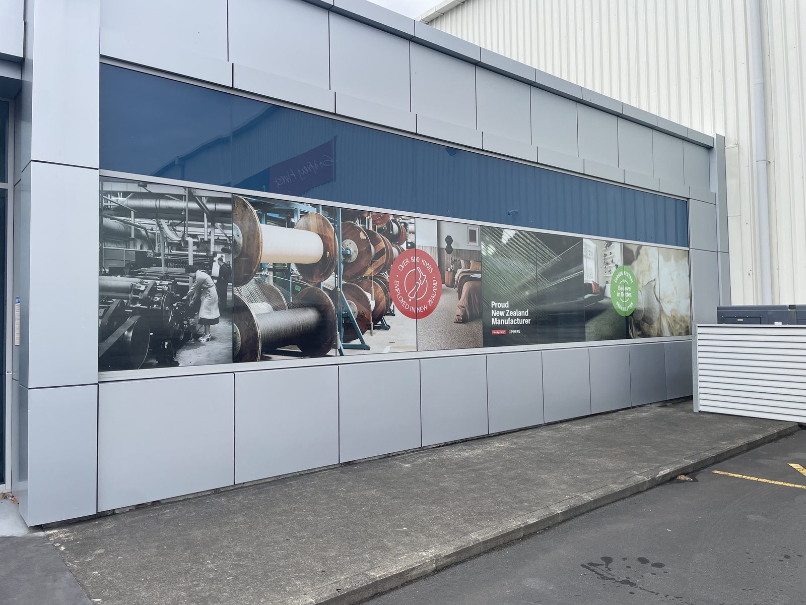 Printed manufacturer signage for the Godfrey Hirst carpet brand family