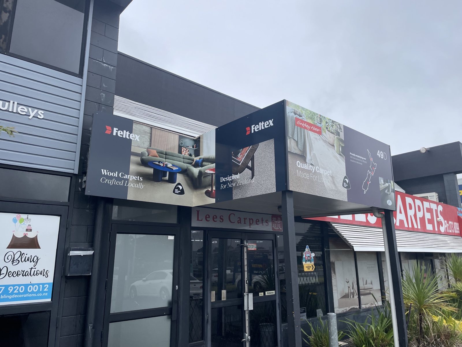 Lees Carpets outdoor fascia with Feltex and Godfrey Hirst branding