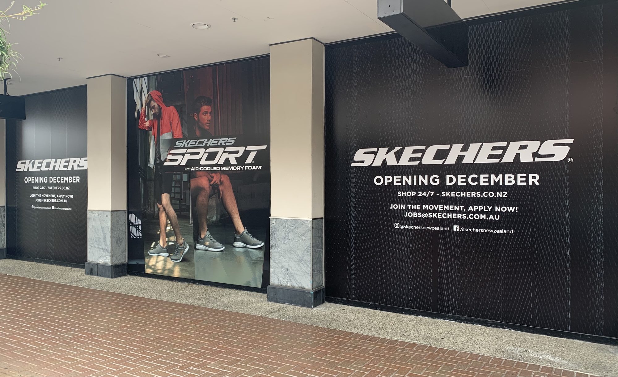 Shopfront sign panel being installed