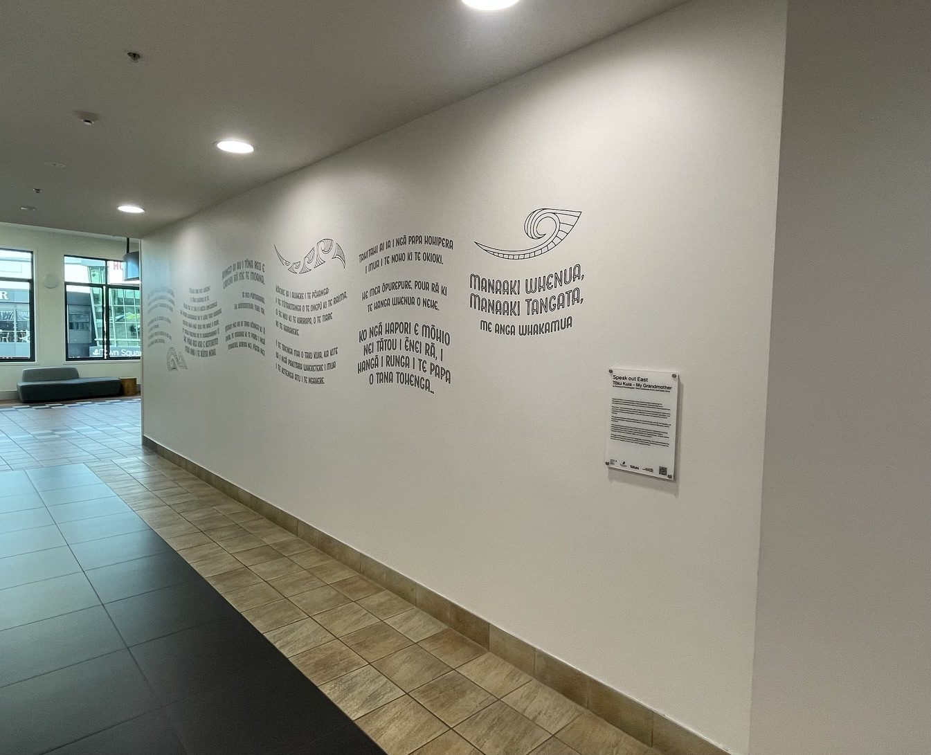 Speak out East corridor wall graphic with Māori text