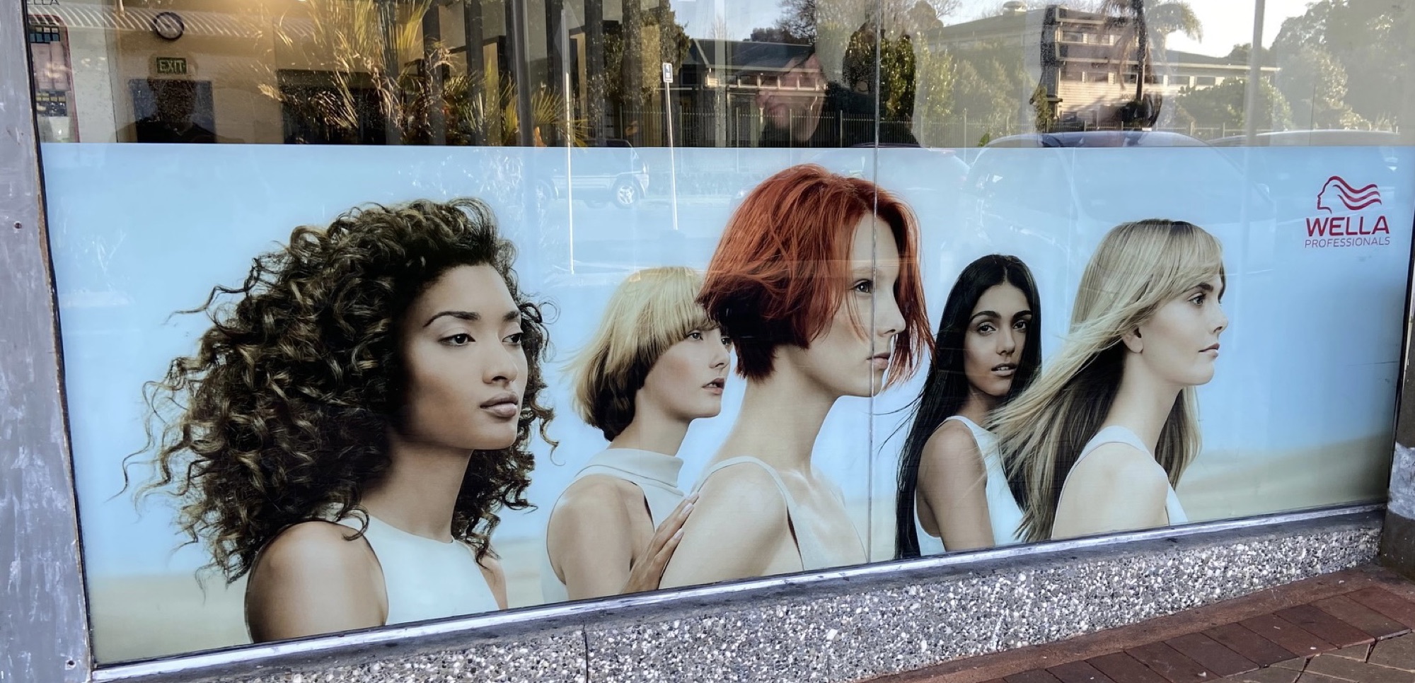 Wella campaign graphics installed on a salon window